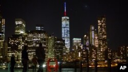 The One World Trade Center spire is lit blue, white and red after New York Gov. Andrew Cuomo announced the lighting in honor of dozens killed in the Paris attacks, Nov. 13, 2015. 