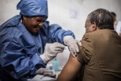 FILE - Dr. Jean-Jacques Muyembe Tamfun gets inoculated with an Ebola vaccine in Goma, DRC, Nov. 22, 2019.