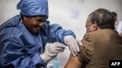 FILE: Dr. Jean-Jacques Muyembe Tamfun gets inoculated with an Ebola vaccine in Goma, DRC, 11.22.2019