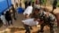 Nepalese soldiers load U.S. AID relief sacks at a staging area near Saturday's massive earthquake's epicenter in the town of Gorkha, Nepal, April 28, 2015. 
