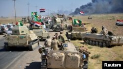 Shi'ite Popular Mobilization Forces (PMF) and Iraqi army members gather on the outskirts of Hawija, Iraq October 4, 2017. 