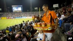 A vendor sells tequenos (cheese sticks) during the baseball game between the Leones de Caracas and the Navegantes del Magallanes in Caracas, Venezuela, Oct. 27, 2015.