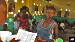 A mother waits for milk at a feeding center in the conflict-torn Central African Republic