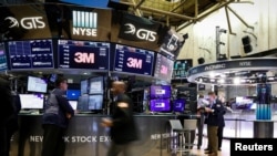 FILE PHOTO: Traders work on the floor at the New York Stock Exchange in New York, Aug. 6, 2019. 