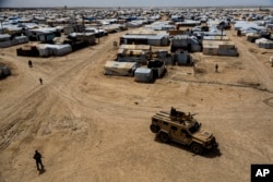 Kurdish forces patrol al-Hol camp, which houses families of members of the Islamic State group in Hasakeh province, Syria, April 19, 2023.