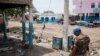 A United Nations peacekeeper looks at the destruction in Malakal on March 4, 2014. 