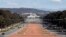 Australia's Parliament House (top) is visible above the old Parliament House (white building below) and Anzac Parade (foreground) in Canberra, (File photo).