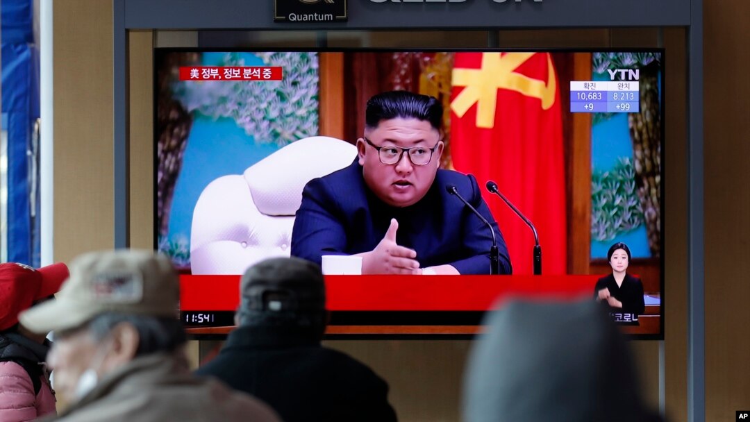FILE - People watch a TV broadcast showing a news program reporting about North Korean leader Kim Jong Un with a file image if him, at the Seoul Railway Station in Seoul, South Korea, April 21, 2020. 