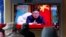 FILE - People watch a TV broadcast showing a news program reporting about North Korean leader Kim Jong Un with a file image if him, at the Seoul Railway Station in Seoul, South Korea, April 21, 2020. 