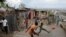 People play soccer on a street next to destroyed houses after Hurricane Matthew hit Jeremie, Haiti.