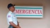 FILE - A police officer stands guard outside a hospital in Santo Domingo, Dominican Republic, June 10, 2019. 