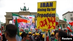 Supporters of the National Council of Resistance of Iran (NCRI) gather to protest against the death penalty in Iran, amid the spread of the coronavirus disease (COVID-19), in front of the Brandenburg Gate in Berlin, Germany, July 17, 2020. REUTERS…