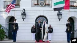 FILE - President Barack Obama, left, shakes hands with Sheikh Mohamed bin Zayed Al Nahyan, Crown Prince of Abu Dhabi, Deputy Supreme Commander of the UAE Armed Forces and Chairman of the Executive Council of the Emirate of Abu Dhabi, as he arrives at the 