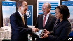 FILE - From left, U.N. Secretary-General Ban Ki-moon converses with LEGO Foundation Chairman Kjeld Kirk Kristiansen and CEO Dr. Randa Grob-Zakhary before adding the last LEGO element to a large scale LEGO model of U.N. Headquarters, built as part of the LEGO Foundation's commitment to the U.N. Global Compact, on Sept. 20, 2013, in New York.