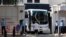 A bus is guided out of the United States Consulate in Chengdu in southwest China's Sichuan province, July 26, 2020.