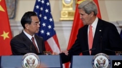 John Kerry and Wang Yi shake hands after making statements before their meeting. Sept. 19, 2013. 