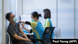 A man receives a dose of China's Sinovac COVID-19 coronavirus vaccine at a community vaccination centre in Hong Kong on February 23, 2021.