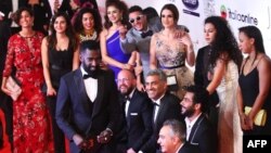 Egyptian actor Ahmed el-Fishawy, top center, poses with cast members of the movie "Sheikh Jackson" during the opening ceremony of the first edition of the El-Gouna Film Festival in Hurghada, Egypt, Sept. 22, 2017.