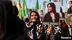 Women protest over the death of Mahsa Amini in Iran, in the Kurdish-controlled city of Qamishli