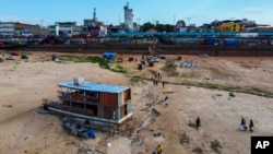 A boat is grounded in the Negro River at the port in Manaus, Amazonas state, Brazil, Oct. 4, 2024, amid severe drought.