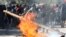 A demonstrator sets a barricade on fire during a protest against Chile's state economic model in Santiago, Oct. 24, 2019. 