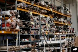 D.Exterior textiles are packed inside the Cose di Maglia factory warehouse in Brescia, Italy on June 14, 2022. They are having a hard time getting paid, due to restrictions tied to the financial sector. (AP Photo/Luca Bruno)