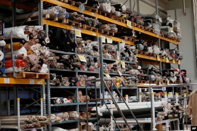 D.Exterior textiles are packed inside the Cose di Maglia factory warehouse in Brescia, Italy on June 14, 2022. They are having a hard time getting paid, due to restrictions tied to the financial sector. (AP Photo/Luca Bruno)