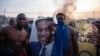 Protesters demonstrate in Maputo, Mozambique, on Oct. 24, 2024, while displaying a spent tear gas canister in front of a poster showing presidential candidate Venancio Mondlane. The ruling party candidate, Daniel Chapo, was announced the winner of the election, sparking protests.