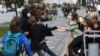 A plainclothes law enforcement officer detains a student during a protest against presidential election results in Minsk, Belarus.