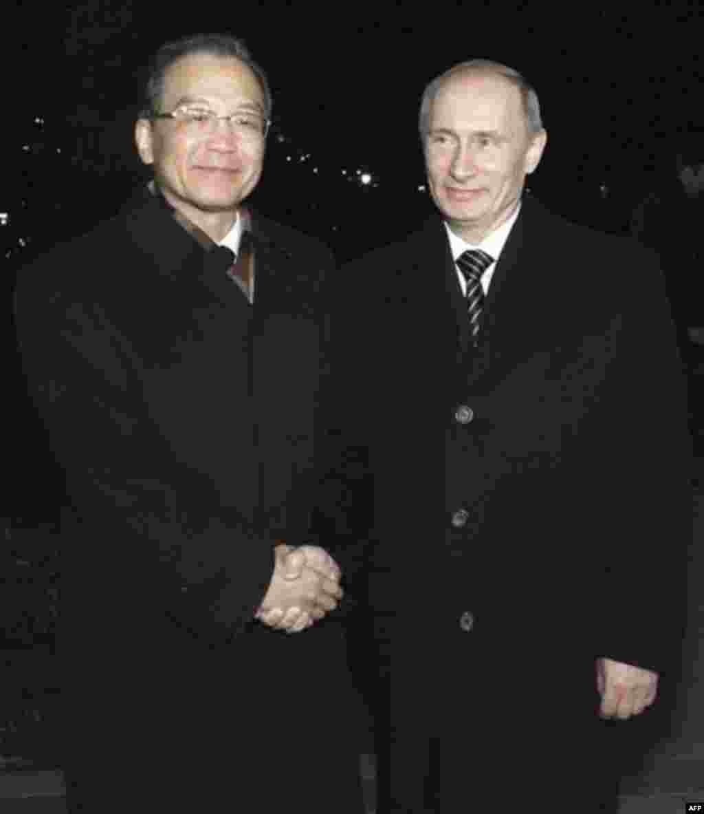 Russian Prime Minister Vladimir Putin, right, greets his Chinese counterpart Wen Jiabao in St. Petersburg, Russia, Monday, Nov. 22, 2010. (AP Photo/RIA Novosti, Alexei Druzhinin, Pool)