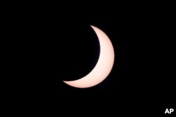 FILE—A hybrid solar eclipse is seen from Lautem, East Timor, April 20, 2023.