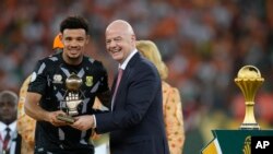 FILE — South Africa's goalkeeper Ronwen Williams receives the goalkeeper of the tournament award from FIFA President Gianni Infantino, at the Olympic Stadium of Ebimpe in Abidjan, Ivory Coast, on February 11, 2024.