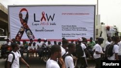 Campaigners walk through a road during a charity walk on HIV/AIDS at Ebute Mata district in Nigeria's commercial capital Lagos, April 21, 2012. 