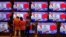 People watch Indian Prime Minister Narendra Modi address the nation amid concerns about the spread of COVID-19 on TV screens inside a showroom in Ahmedabad, March 19, 2020.