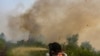 Firefighters spray water to extinguish brush fires in Kampar, Riau province, Indonesia, Sept. 11, 2019. 