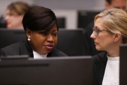 FILE - International Criminal Court prosecutor Fatou Bensouda, left, speaks with a colleague in The Hague, Netherlands, on July 8, 2019.