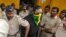 An accused man (face covered), surrounded by Indian policemen, is taken to a court in Mumbai, India, Sept. 11, 2015. 