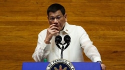 FILE - Philippine President Rodrigo Duterte gestures as he delivers his annual state of the nation address at the House of Representatives in Manila on July 26, 2021. (Photo by Lisa Marie David / Pool / AFP)