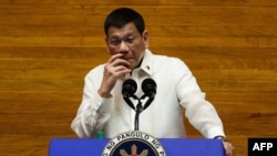 Philippine President Rodrigo Duterte gestures as he delivers his annual state of the nation address at the House of Representatives in Manila on July 26, 2021. (Photo by LISA MARIE DAVID / POOL / AFP)