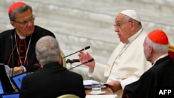 FILE - Maltese cardinal Mario Grech (L), Pope Francis (C) and cardinal Carlos Aguiar Retes attend the Second Session of the 16th Ordinary General Assembly of the Synod of Bishops at the Paul VI audience hall, in The Vatican, Oct. 2, 2024. 