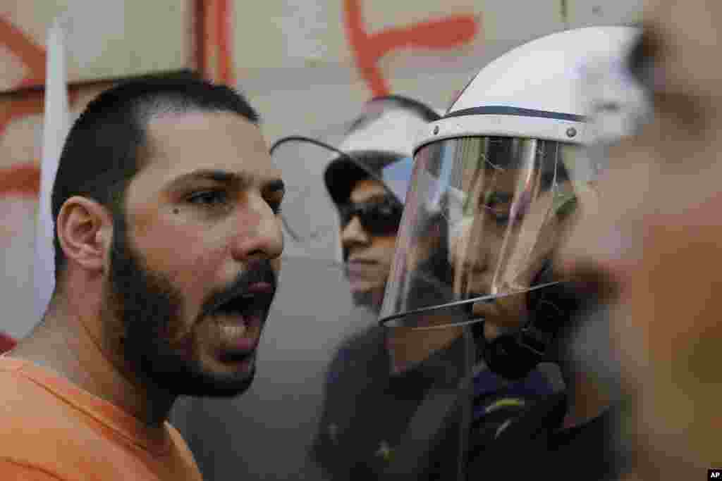 A member of the Communist-affiliated PAME labor union shouts slogans at the police during an anti-austerity protest outside of central Athens, July 3, 2015.