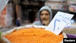 An Egyptian man buys consumer goods as yellow lentils, at a vegetable market in Cairo, Egypt January 10, 2017. 