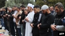 FILE —Muslim devotees offer first Friday noon prayers of the Islamic holy fasting month of Ramadan against the backdrop of the Dome of the Rock at the compound of the Al-Aqsa mosque in the Old City of Jerusalem on March 15, 2024.