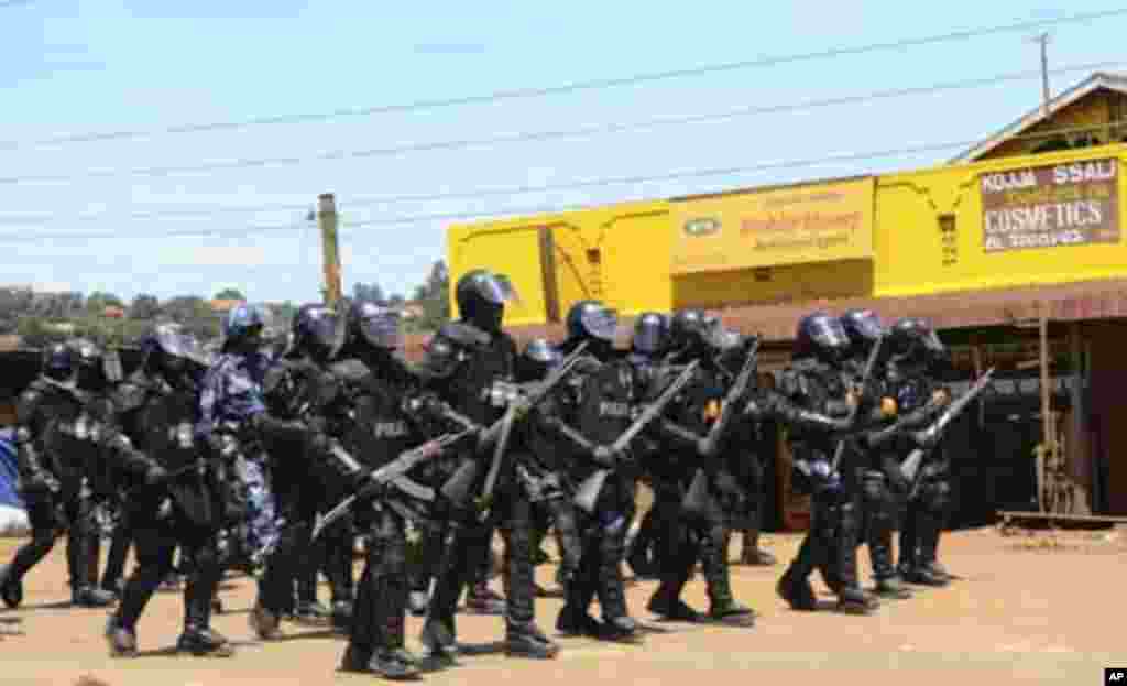 Anti-riot police walk in a formation as they patrol along a street in the Kalerwe suburb of the capital Kampala April 14, 2011. Ugandan opposition leader Kizza Besigye, President Yoweri Museveni's closest rival in February elections, was injured while tak