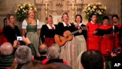 The Kroell Family Singers, center, sing "Silent Night" with the Choir of Trinity Wall Street and Trinity Youth Chorus during a celebration of the anniversary of the song at Trinity Church, Nov. 27, 2018, in New York.