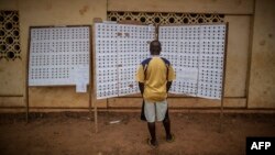 A Gabonese voter checks the registry at a polling station in the Rio district during the presidential election on Aug. 27, 2016, in Libreville.