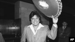 FILE - Los Angeles Dodger pitcher Fernando Valenzuela tips his sombrero at a news conference after he was named National League Rookie of the Year, in Los Angeles, Dec. 2, 1981.