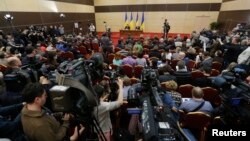 FILE - Journalists listen to ousted Ukrainian President Viktor Yanukovich during a news conference in the southern Russian city of Rostov-on-Don, Feb. 28, 2014.