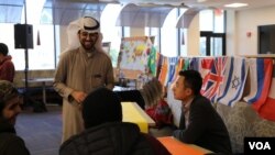 Hadi Alajmi, president of IUSB's International Student Organization, speaks with Thanksgiving attendees. (Esha Sarai/VOA)