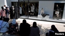 Tourists wait to enter a Chanel store in Istanbul, Turkey, Aug. 13, 2018.